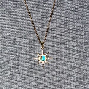 Radiant Gold Starburst Necklace with Blue Center